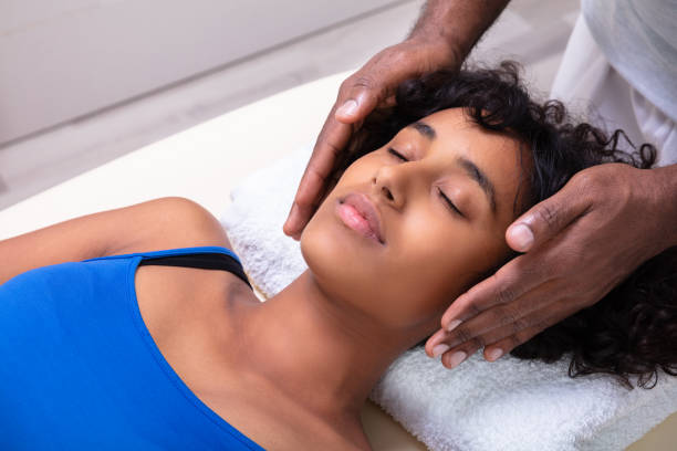 Woman Having Reiki Healing Treatment Close-up Of Therapist's Hand Performing Reiki Treatment On Young Woman In Spa reiki stock pictures, royalty-free photos & images