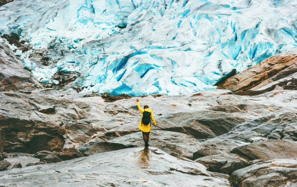 Woman hiking at Nigardsbreen glacier Travel Lifestyle ecology concept...