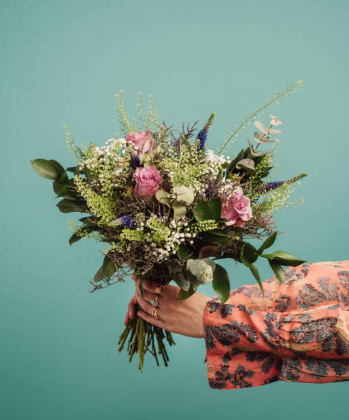 Woman holding a big bouquet of flowers stock photo