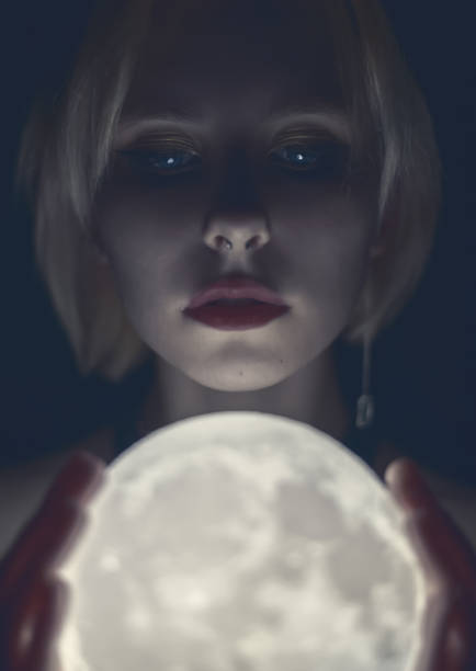 Woman holding a glowing moon. stock photo