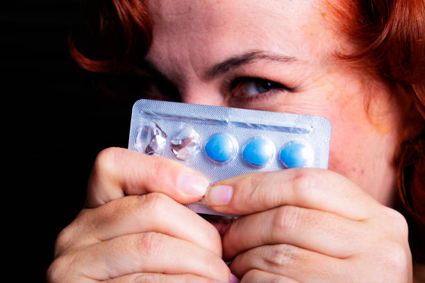 Woman holding blue pills Woman holding blue pills anti impotence tablet stock pictures, royalty-free photos & images