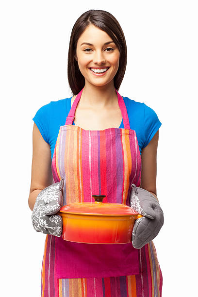 Woman Holding Casserole Dish - Isolated Portrait of a happy young woman holding casserole dish. Vertical shot. Isolated on white. casserole dish stock pictures, royalty-free photos & images