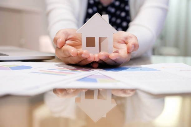 woman holding house model. Woman holding house model on her hand. Dreams. home insurance stock pictures, royalty-free photos & images