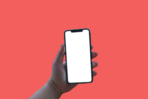 Woman holding iPhone 11 Pro max. Apple iPhone 11 Pro max black with blank screen template - modern frameless design on pink background.