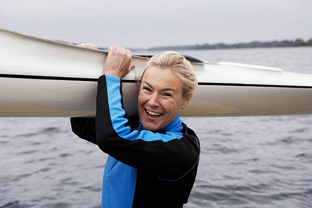 woman holding kayak - woman kayaking bildbanksfoton och bilder