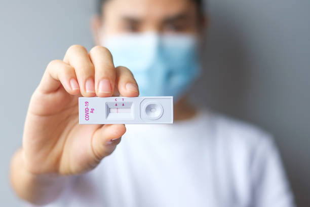 woman holding Rapid Antigen Test kit with Negative result during swab COVID-19 testing. Coronavirus Self nasal or Home test, Lockdown and Home Isolation concept stock photo