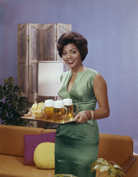 Woman holding tray of beer glasses in living room, smiling, portrait  1964 stock pictures, royalty-free photos & images