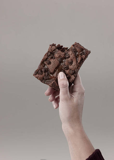woman holds brownie stock photo