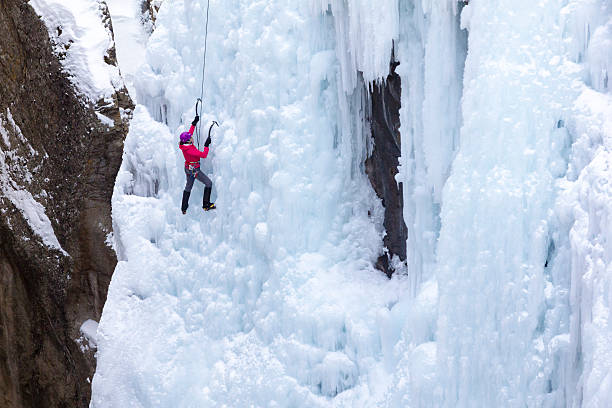 Woman Ice climbing stock photo