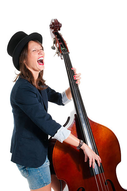 Woman in black hat play double bass stock photo