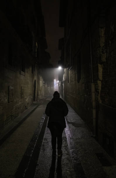 Woman in dark street stock photo