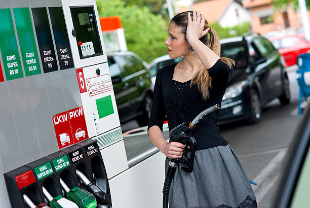 woman in gas station stock photo