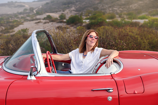 Woman in her classic sports car