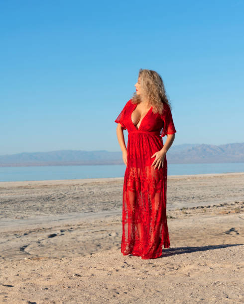 Woman in red dress at the desert stock photo