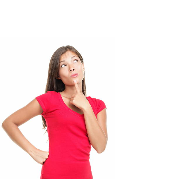 Woman in red dress thinking with finger on her chin stock photo
