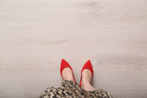 Woman in red shoes standing on wooden floor, top view. Space for text Woman in red shoes standing on wooden floor, top view. Space for text cover Shoes for women stock pictures, royalty-free photos & images
