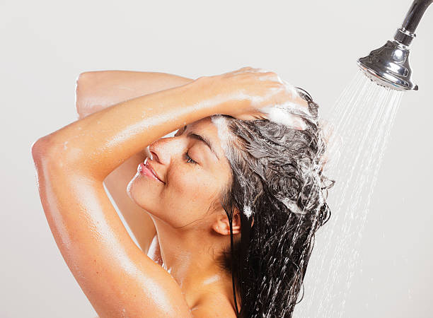 woman in shower - woman washing hair stockfoto's en -beelden