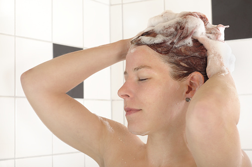 Young Woman Washing Hair While Taking Shower Stock Image 