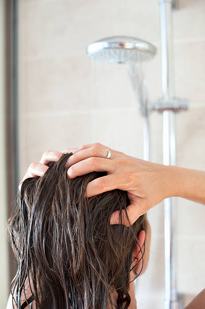 woman in shower washing her hair - woman washing hair stockfoto's en -beelden