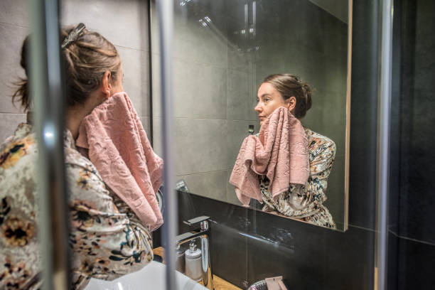 Woman in Silky Bathrobe During Evening Routine in the Bathroom stock photo