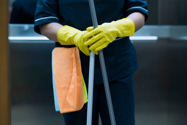 Woman in the office with cleaning implements Latin woman between 20-35 years working as a cleaner in the office with cleaning implements office cleaning stock pictures, royalty-free photos & images