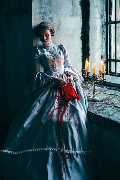 Woman in victorian dress Woman in victorian dress imprisoned in a dungeon victorian gown stock pictures, royalty-free photos & images
