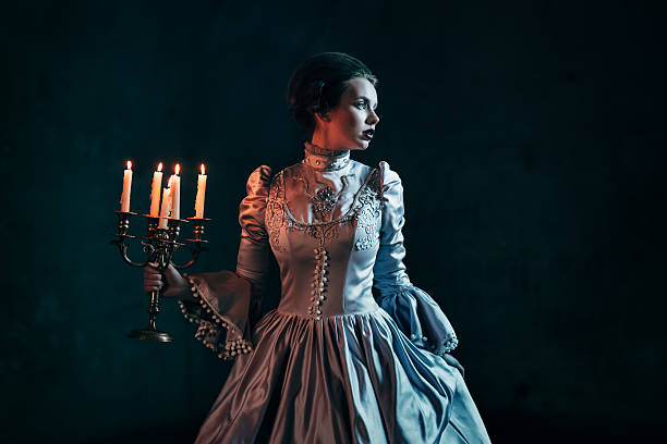 Woman in victorian dress Woman in victorian dress imprisoned in a dungeon victorian gown stock pictures, royalty-free photos & images