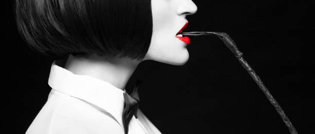 Woman in wig bite whip profile selective coloring banner stock photo