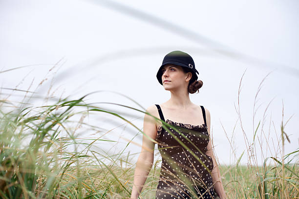 Woman in windy grass stock photo