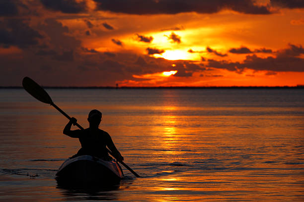 woman kayaking during sunset in Florida Keys stock photo