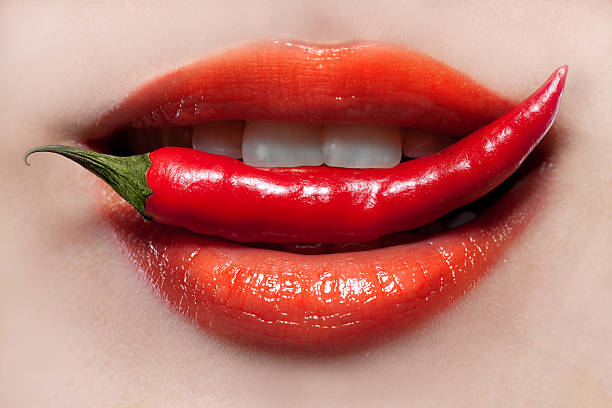 Woman lips and chili pepper stock photo