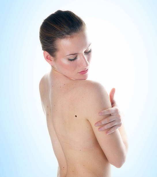 woman looking mall on her skin stock photo