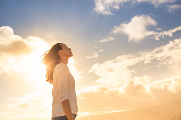 Woman looking up into the sky and thinking about her future. stock photo