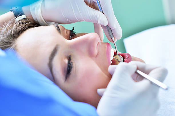 Woman lying in the dentist's chair having a checkup stock photo