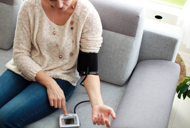Woman Measuring Her Blood Pressure stock photo