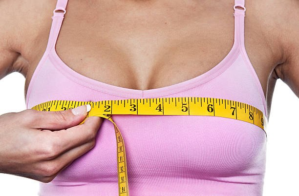 Woman measuring her bust line stock photo