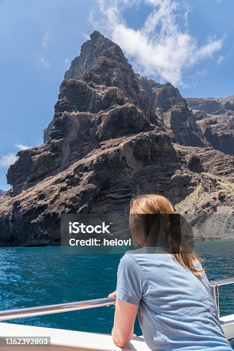 istock Woman on a boat watching Los Gigantes cliffs 1362392803