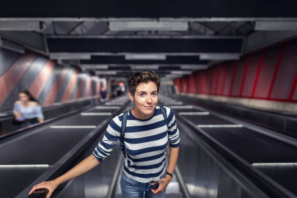 kvinna på en rulltrappa på en tunnelbanestation - summer stockholm bildbanksfoton och bilder