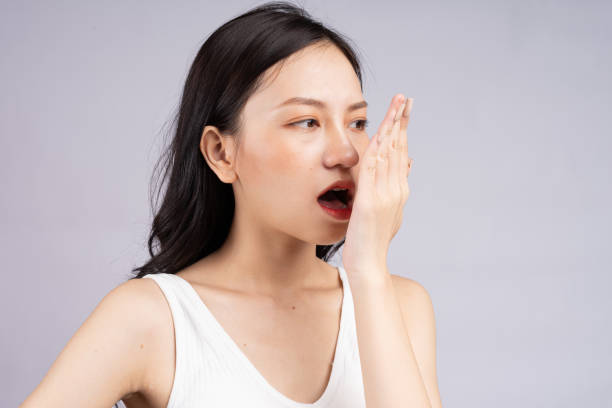 Woman on background Asian woman feels uncomfortable because of bad breath bad breath stock pictures, royalty-free photos & images