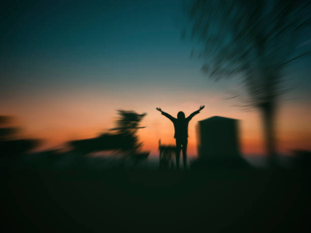 woman open arms under the sunrise stock photo