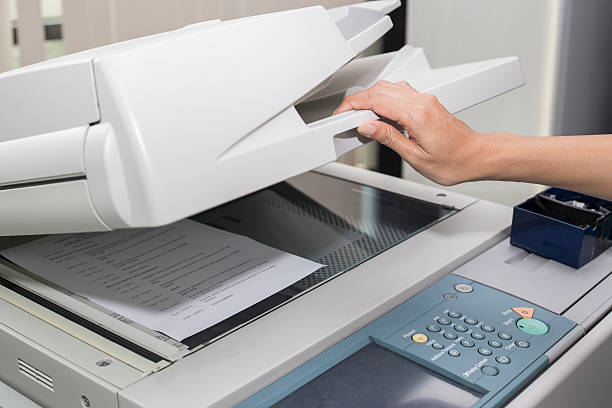 woman opening a photocopier stock photo