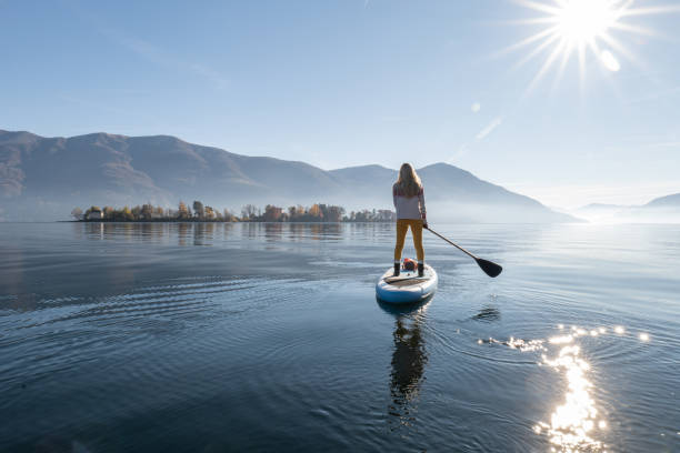 Woman paddling on a stand up paddle board stock photo