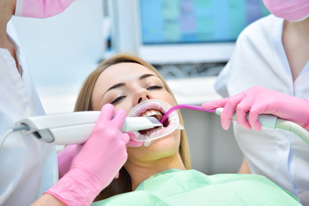 Woman patient having dental 3d scanning done by her dentist. stock photo