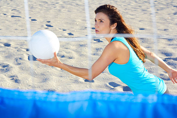 Woman Playing Beach Volleyball stock photo