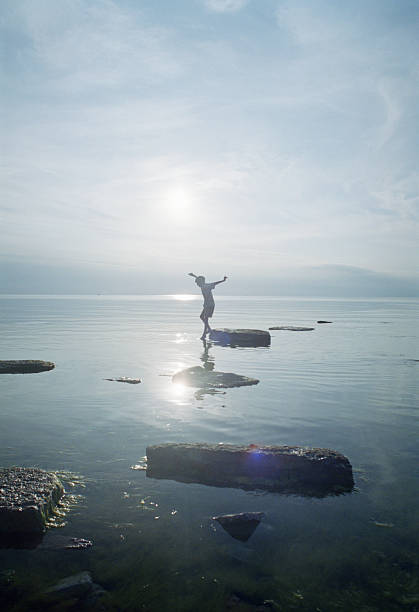 woman playing on rocks in lake - gotland bildbanksfoton och bilder