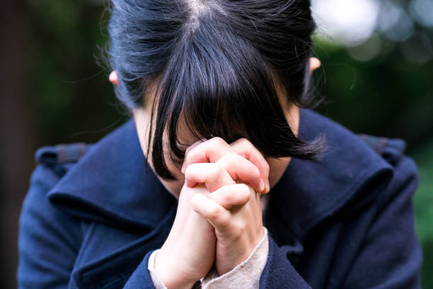 Woman praying at outside stock photo