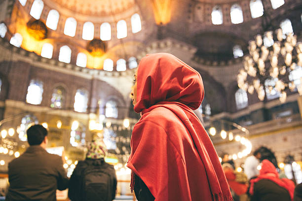 Woman Praying Inside A Mosque stock photo