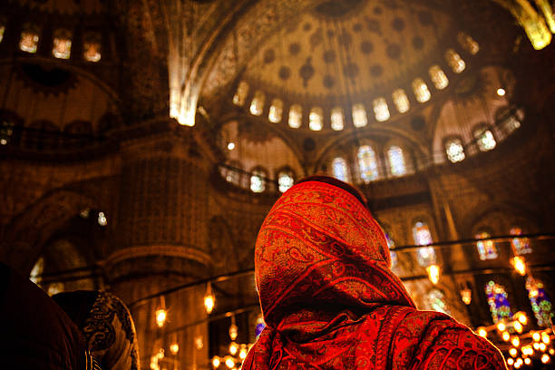 Woman praying inside a mosque stock photo