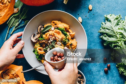 istock Woman preparing autumn pumpkin meal 1257464418