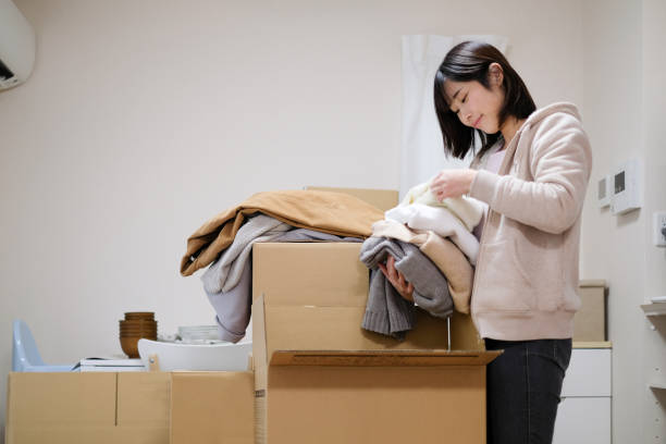 woman packing clothes in box